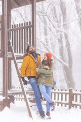 Couple relaxing outdoors on snowy winter day