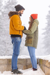 Couple relaxing outdoors while on winter vacation