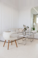 interior of a bright living room in a luxurious baroque style with white walls decorated with antique stucco