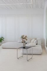 interior of a bright living room in a luxurious baroque style with white walls decorated with antique stucco