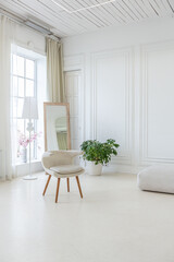 interior of a bright living room in a luxurious baroque style with white walls decorated with antique stucco