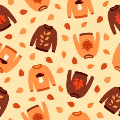 Rolgordijnen Seamless pattern with cute autumn sweaters and leaves. Brown and orange pullovers on beige background. Cartoon flat style. Vector illustration © Yaryna