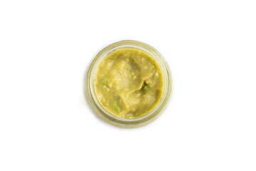 Baby puree with vegetable mix, broccoli, avocado in glass jar isolated on white, top view