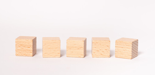 Five empty wooden cubes with place for letters