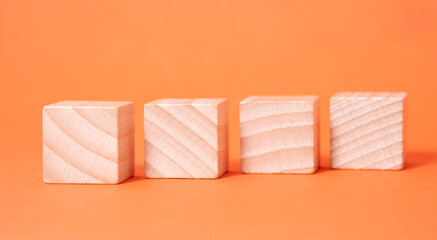 Four empty wooden cubes with place for letters