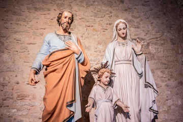 Naklejka premium Religious background with holy christian family statues