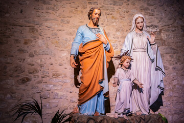 Religious background with holy christian family statues