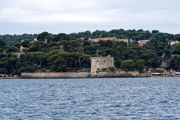 Fototapeta na wymiar Fortification at bay of Mediterranean Sea at City of Toulon on a cloudy late spring day. Photo taken June 9th, 2023, Toulon, France.