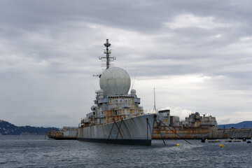 Moored war ships at French Navy Naval Base at City of Toulon on a cloudy late spring day. Photo...