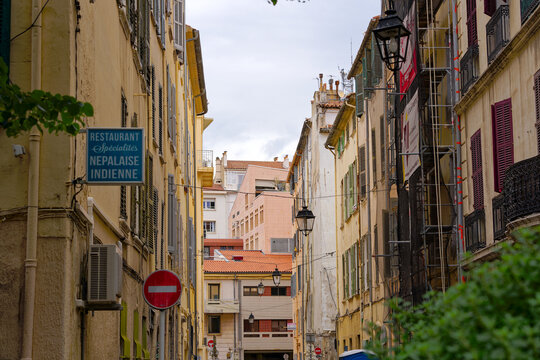 Alley at French City of Toulon with sign of Indian and Nepalese restaurant on a cloudy late spring day. Photo taken June 9th, 2023, Toulon, France.