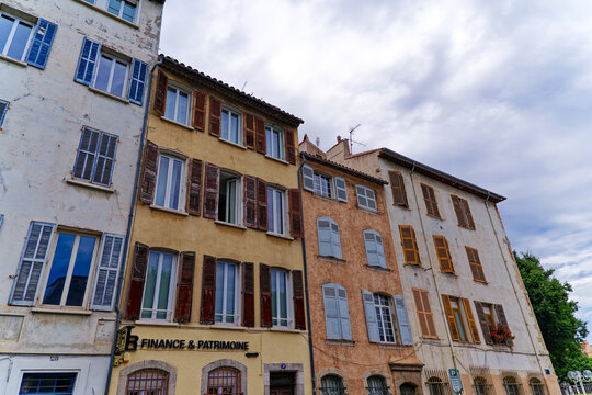 Weathered colorful facades of old residential houses at French City of Toulon on a cloudy late spring day. Photo taken June 9th, 2023, Toulon, France.
