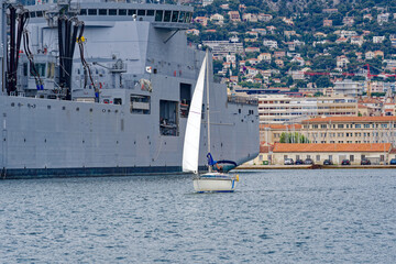 Moored supply warship and tanker of French Navy at Toulon Naval Base on a cloudy spring day. Photo taken June 9th, 2023, Toulon, France. © Michael Derrer Fuchs