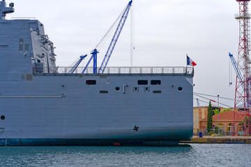 Moored supply warship and tanker of French Navy at Toulon Naval Base on a cloudy spring day. Photo...
