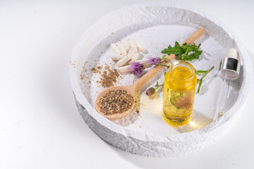 Milk Thistle supplies, powder and oil. Silybum marianum, natural organic wild flower superfood product - whole and grain seeds, pills, oil with fresh thistle flowers