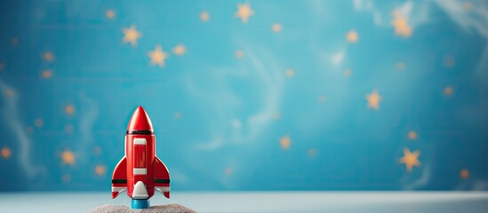 Fototapeta na wymiar A rendered 3D toy space rocket in red and blue isolated pastel background Copy space