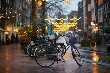 Bicycles parked on a street on a rainy winter day in Amsterdam, the Netherlands