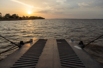 Obraz premium Watching the beautiful sunset on board a ferry on the Amazon river to Manaus - Traveling Brazil, South America