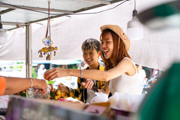 Group of Happy Asian people tourist buying and eating street food with using mobile app on...