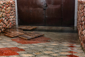 The entrance to the garage is flooded with water after the rain.