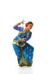 Bharatanatyam dance. Beautiful, talented indian woman in traditional clothes dancing against white...