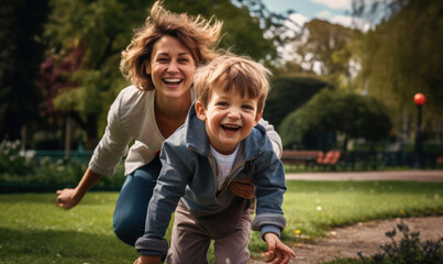 Fototapeta premium Mother playing with son in an outdoor park during Children's Day celebrations.