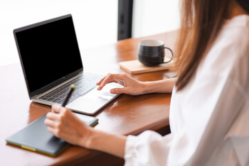 Businesswomen use digital tablet with stylus pen and analysis finance data of new startup on laptop