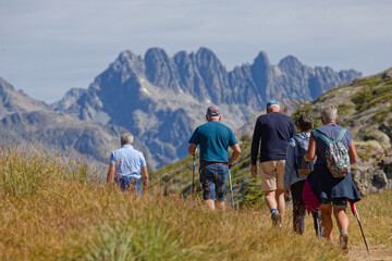 OZ-EN-OISANS, FRANCE, August 8, 2023 : Hikers walk on paths of Plateau des Petites Rousses