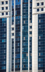 Fototapeta premium many windows and walls facade of a modern skyscraper without people