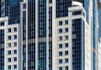 Fototapeta premium many windows and walls facade of a modern skyscraper without people