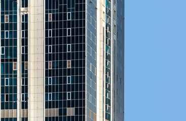 many windows and walls facade of a modern skyscraper without people