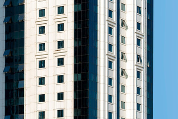 many windows and walls facade of a modern skyscraper without people