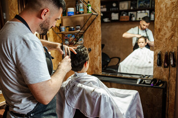  little boy at the barber shop getting his haircut