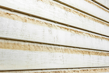 Dirty vinyl siding with stains of dust and water.