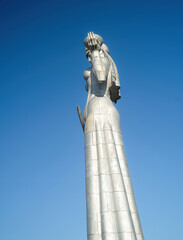 The statue of Mather Georgia with a sword and wine on a blue  sky background.