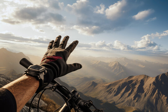 First Person View, A Mountain Bikers Hand Reaches For The Distant Horizon