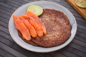 Salted salmon fillet with buckwheat pancakes and lime