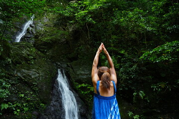 Woman standing in Yoga Position at Kijoka Seven Falls in Okinawa - 沖縄 大宜味...