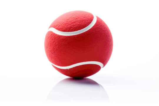 Dynamic Tennis: Red ball as sports equipment set the stage for a vibrant game, isolated against a white background, embodying leisure and action.