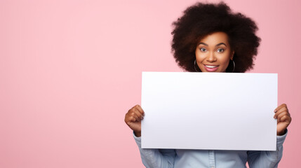African American Woman Holds Blank Placard for Customization on Pastel Pink Background. Creative Space for Messages & Promotions.