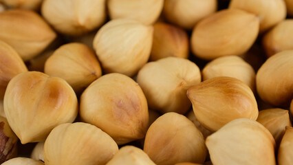 Heap of roasted hazelnuts close up