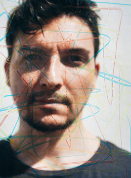 Man behind glass with colorful lines