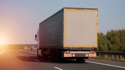 Modern semi-trailer trucks on the highway driving in the right lane. Commercial vehicle for shipping and post delivery. Shipping of the goods on land door-to-door