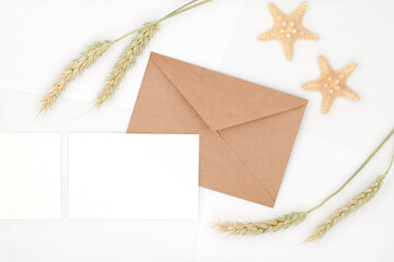 Universal background for holiday card or business formal communication, kraft envelope and blank sheets, business cards on white, top view