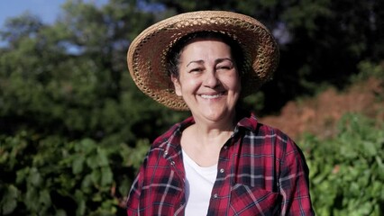 Happy Latin senior farmer woman work at rural farm smiling at camera - Small business agriculture and harvest concept - Powered by Adobe