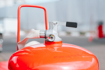 Close-up of a red gas cylinder outdoors