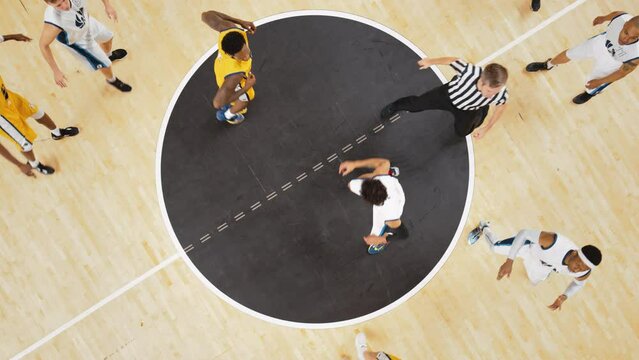College Basketball Playoffs: White Team Player Winning Face-Off Opening Tip From a Rival Team Player. Slow Motion Top View Cinematic Footage from a Live TV Replay on a Sports Channel