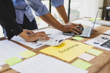 Meeting of colleagues is discussing financial statement analysis in accounting and brainstorming business strategy plans.