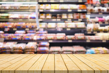 Empty wood table top with blur meat shelves in supermarket background for product display