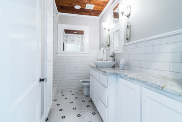Light and bright white with black & white tile bathroom in 1950s house,  mix of modern and original 