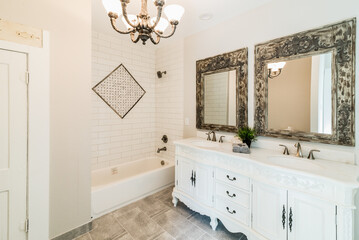 Remodeled White Bathroom with Double Vanity, Mirrors, and Tile Inlay, eclectic boho decor	